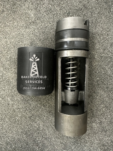 Float Installer beside the exposed float valve, showing Baker Oilfield Services branding